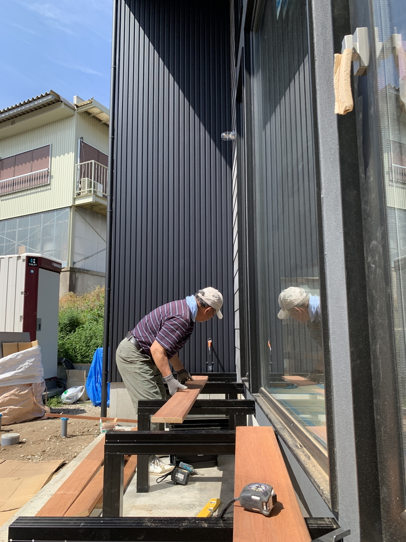 職人さんがリビングの外側にウッドデッキを創っている様子