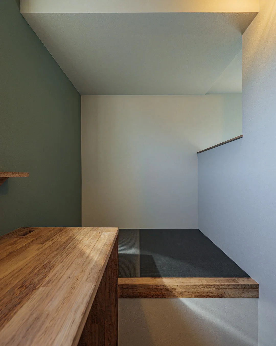 書斎の横に設けられた、黒い畳が敷かれたモダンな小上がりの休憩スペース。