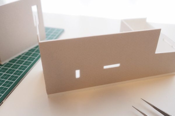 白いデスクの上に作りかけの模型が置いてある